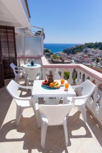 a white table and chairs on a balcony at Castello Apartments in Ulcinj