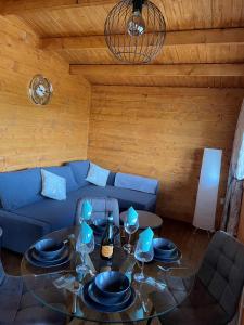 a living room with a table and a blue couch at Alpaca My Bags! at Andean Alpacas in Mullingar