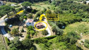an aerial view of a house with a yellow sign at Villetta I Due Pini in Capoliveri