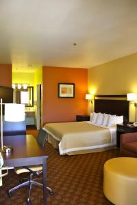 a hotel room with a large bed and a desk at Days Inn by Wyndham Globe in Globe +48 photos