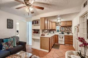 a living room with a couch and a kitchen at Flamingo Casita in West Palm Beach