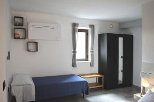 a bedroom with a blue bed and a window at B&B Li Gutti in Aieta