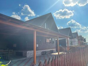 una casa con una recinzione in legno su una terrazza di Cabana Daiana 2, Cazare Baile Figa, Bistrita-Nasaud a Beclean