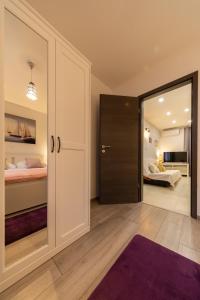 a bedroom with a door leading to a bedroom with a bed at Apartment Vanja konoba in Komiža