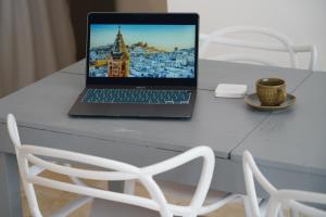 a laptop computer sitting on a table next to a chair at Il Biancospino - graziosa Dimora con VASCA in CAMERA in Ostuni