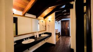 un bagno con due lavandini e un grande specchio di Johnscher by SJ - San Juan Curitiba a Curitiba