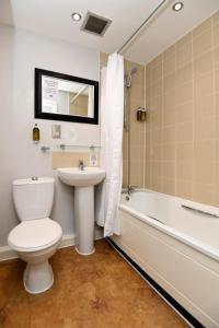 a bathroom with a toilet and a sink and a bath tub at Lamb & Flag Inn in Abergavenny