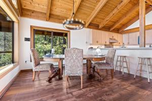 a kitchen and dining room with a table and chairs at Amazing Views - Modern Home - SH #14 in Bear Valley
