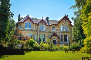 a large house with a garden in front of it at Heatherlie House in Selkirk