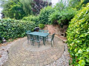 a table and chairs sitting on a brick patio at Spacious Two Bedroom House - TM in Southport