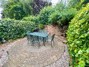 a table and chairs sitting on a brick patio at Spacious Two Bedroom House - TM in Southport