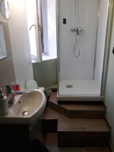 a bathroom with a white sink and a shower at Studio Zen in Boulogne-sur-Mer