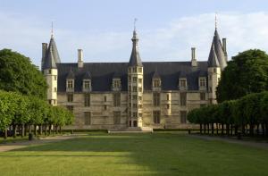 un gran castillo con árboles delante de él en Kyriad Hotel Nevers Centre, en Nevers