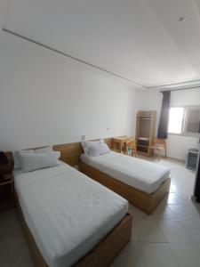 Un ou plusieurs lits dans un hébergement de l'établissement HOTEL CASTIYA