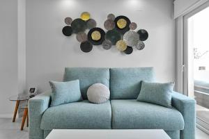 a blue couch in a living room with a wall at Apartment Golden Luna in San Pedro del Pinatar +60 photos