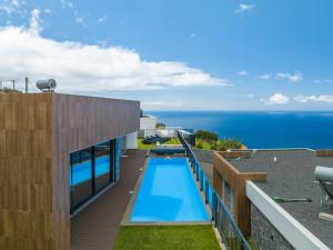 a view of a swimming pool on the roof of a house at Casa Mozart I in Estreito da Calheta