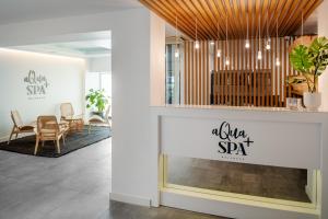 a lobby with chairs and a table in a room at Arrecife Gran Hotel & Spa in Arrecife