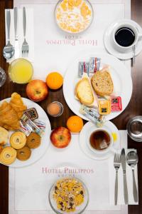 a table with two plates of breakfast food on it at Hotel Philippos in Volos