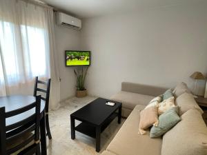 a living room with a couch and a table at Apartamento Veradulce, Vera Playa in Vera