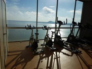 a group of exercise bikes in a room with a view of the ocean at Ecusuites Studio Two Riverfront con Jacuzzi Hidro Privado in Guayaquil