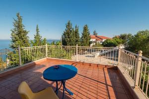 a balcony with a blue table and chairs at Marathos Sea View Apartments in Marathos