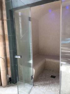 a shower with a glass door in a bathroom at 3 BR Luxury Apt at Highland Club - Fort Augustus in Fort Augustus