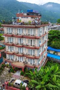 a large building with people on the balconies of it at Hotel Point Pokhara in Pokhara