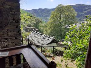 a view from a stone building with mountains in the background at Albergue ESCANLAR in Lugo