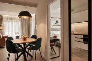 a dining room with a table and chairs in a room at Hestia - Asklipiou 61 in Athens