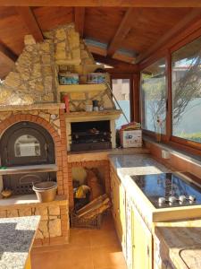 a kitchen with a stone oven in the middle at Nonna Genoveffa, camere in Infernetto
