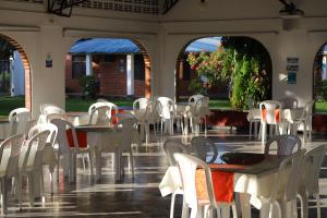 - un groupe de tables et de chaises dans un pavillon dans l'établissement Club Bella Suiza - Carlos Ossa Escobar, à Villavicencio