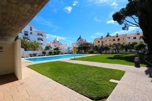 a view of a park with a pool and buildings at Marina Algarve-CleverDetails, located on the marina close to all main amenities in Vilamoura