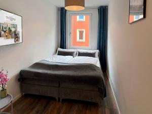 Säng eller sängar i ett rum på Nurban Apartments City 2