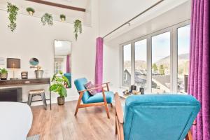 a living room with a desk and chairs at The Apple Loft in Ambleside +16 photos