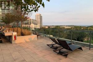 a group of chairs sitting on top of a building at SkySide Downtown Condo - Free Parking in Toronto