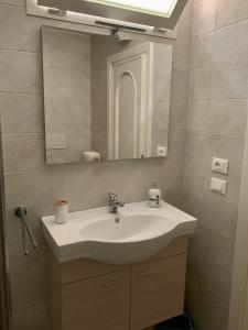a bathroom with a sink and a mirror at InterMezzo - located in the center of Salento equidistant from the 2 seas in Scorrano