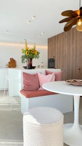 a living room with a couch and a table at House Santa Maria - North Sea Stays in De Haan