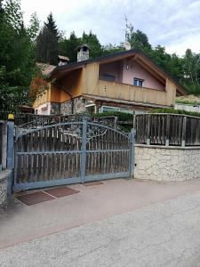 a house with a wooden gate in front of it at Pit Stop Cadore in Valle di Cadore