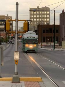 a green trolley driving down a city street at Comfortable Suite with private entrance & private bathroom in El Paso