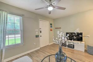 a living room with a vase with flowers in it at Auburn Condo with 2 Pools Less Than 2 Mi to University! in Auburn