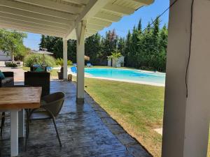 奇克拉納－德拉弗龍特拉的住宿－Chalet Brisas del Mar，一个带桌椅的庭院和一个游泳池