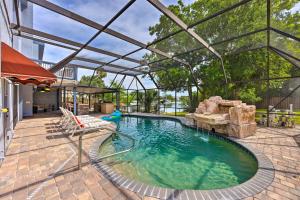 an indoor swimming pool with a large glass roof at Lovely Palm Coast Retreat with Outdoor Kitchen in Palm Coast