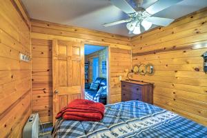 a bedroom with a bed and a ceiling fan at Quaint Lake Jefferson Cabin with Deck and Gas Grill! 