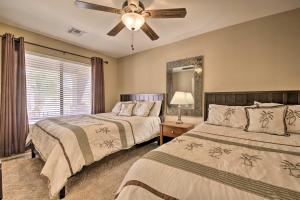 a bedroom with two beds and a ceiling fan at Chic Maricopa Getaway with Outdoor Oasis and Pool in Maricopa +37 photos