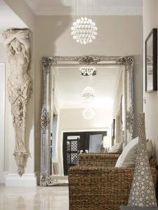 a large mirror in a room with a bed at Windfalls Boutique Hotel in Crawley