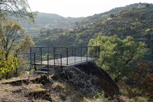 a bench on the side of a hill with trees at Quinta de São Pedro in Barrô