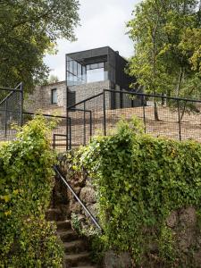 a glass house on top of a brick building at Quinta de São Pedro in Barrô