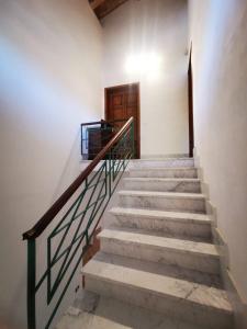 a staircase in a building with a wooden door at Casamare Hotel in San Vincenzo