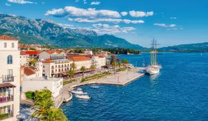 a view of a city with a boat in the water at Chic apartment in the City Center by the sea in Tivat