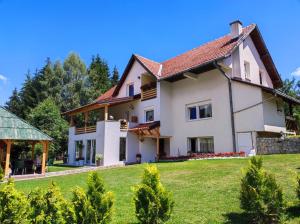 a large white house with a yard at Dusa Zlatibora in Zlatibor